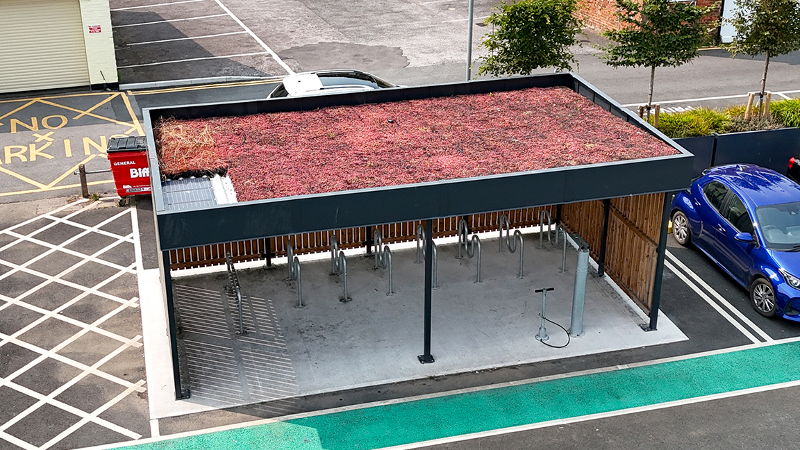 Cycle Hub with green roof and solar lighting - featuring bike parking including cargo bikes - plus repair station and bike pump
