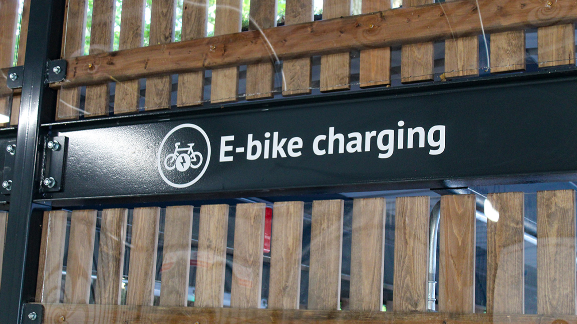 Cycle Hub with green roof - featuring bike parking including cargo bikes - plus repair station and bike pump